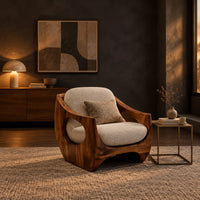 Low accent chair with a sculpted wood shell and circular side openings in a dark living room at golden hour