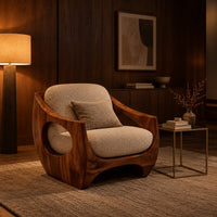 Low accent chair with a sculpted wood shell and circular side openings in an evening living room with walnut wall paneling