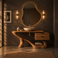 Sculpted bathroom vanity with a flowing base and a two drawer box in a dark bathroom at golden hour