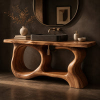 Corner detail of open frame vanity with a freeform slab top and a sculpted looping base beside wood, brass and linen samples