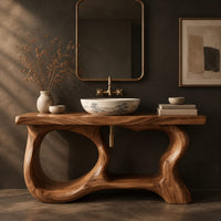 Corner detail of freestanding vanity base with looping open legs and a thick wood slab top beside wood, brass and linen samples
