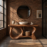 Freestanding vanity base with looping open legs and a thick wood slab top in an industrial loft bathroom with exposed brick