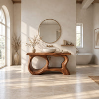 Freestanding vanity base with looping open legs and a thick wood slab top in a bright open plan bathroom
