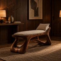 Sculpted bench with a cushioned seat and open loop legs in an evening entryway with walnut wall paneling