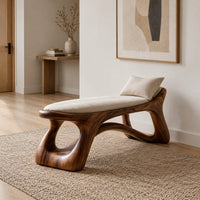 Sculpted bench with a cushioned seat and open loop legs in a Scandinavian entryway with white walls
