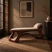 Sculpted bench with a cushioned seat and open loop legs in an industrial loft entryway with exposed brick