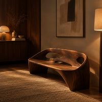 Sculpted bench with a cutout back and swept side legs in an evening entryway with walnut wall paneling