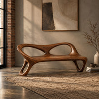 Wood bench with two oval back openings and looped legs in an industrial loft entryway with exposed brick