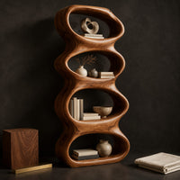 Corner detail of tall sculpted bookshelf with four stacked oval openings beside wood, brass and linen samples