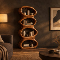 Tall sculpted bookshelf with four stacked oval openings in a dark living room at golden hour