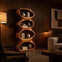 Tall sculpted bookshelf with four stacked oval openings in an evening living room with walnut wall paneling