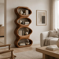 Tall sculpted bookshelf with four stacked oval openings in a Scandinavian living room with white walls
