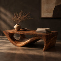 Rectangular coffee table with a thick top over a swooping open loop base, three-quarter view showing the grain