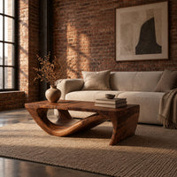 Rectangular coffee table with a thick top over a swooping open loop base in an industrial loft living room with exposed brick