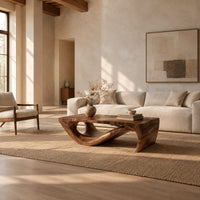 Rectangular coffee table with a thick top over a swooping open loop base in a bright open plan living room