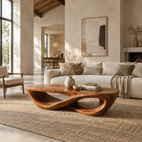 Coffee table with a twisting figure eight base and a thick oval top in a bright open plan living room