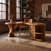Kidney shaped wood desk with a tree trunk leg and a drawer pedestal in an industrial loft home office with exposed brick