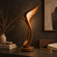 Corner detail of tall floor lamp shaped like a ribbed feather wing on a round wooden base beside wood, brass and linen samples