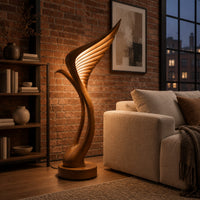 Tall floor lamp shaped like a ribbed feather wing on a round wooden base in an industrial loft living room with exposed brick