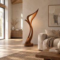 Tall floor lamp shaped like a ribbed feather wing on a round wooden base in a bright open plan living room