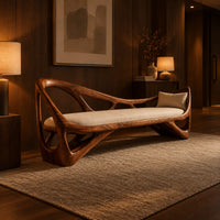 Sculpted wooden bench with open branching sides and a padded seat in an evening entryway with walnut wall paneling