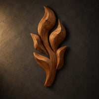Sculpted wooden leaf cluster wall art in layered shapes, three-quarter view showing the carved depth