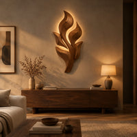 Sculpted wooden leaf cluster wall art in layered shapes above a low console in an evening living room
