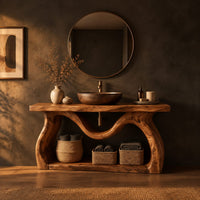 Bathroom vanity with sculpted wavy legs and an open lower shelf in a dark bathroom at golden hour