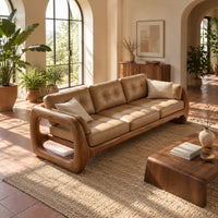 Three seat sofa with tufted cushions and open loop wooden arms in a bright living room with arched windows and plants