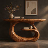 Corner detail of oval top makeup vanity on a looping pedestal base with a small inner shelf beside wood, brass and linen samples