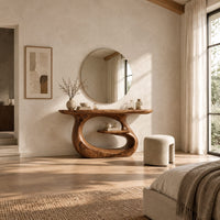 Oval top makeup vanity on a looping pedestal base with a small inner shelf in a bright open plan bedroom