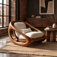 Sculpted lounge chair with a thick looping wood frame and open side cutouts in an industrial loft living room with exposed brick