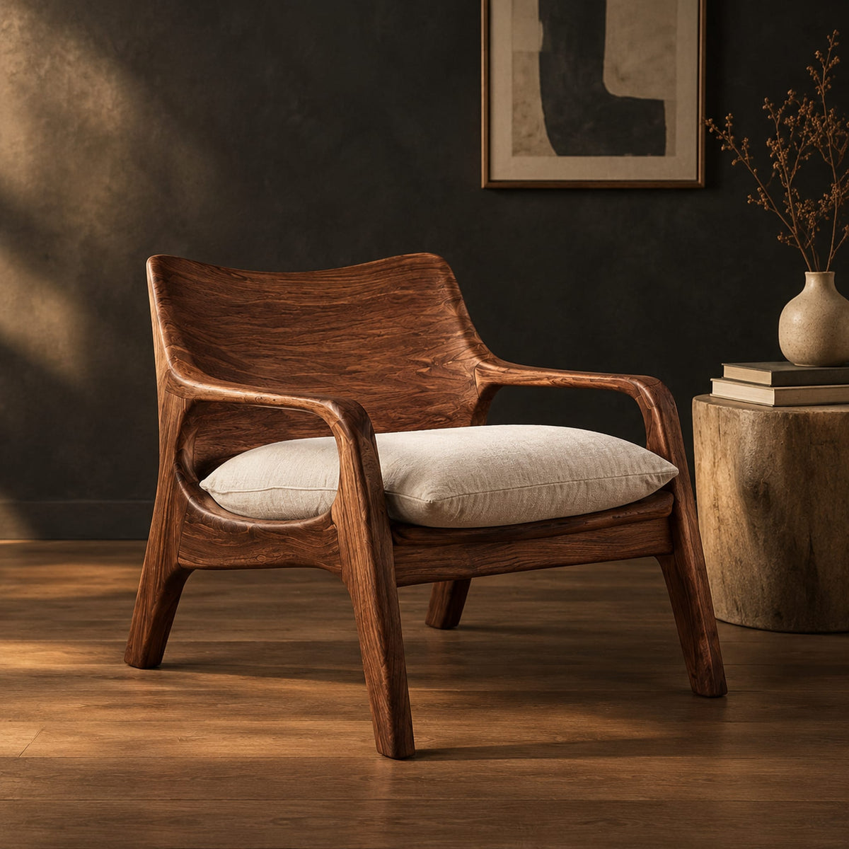 Lounge chair with looped arms and a swept wooden back in a dark studio against a charcoal plaster wall