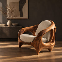 Sculpted lounge chair with an open cutout wood frame and cream cushions, three-quarter view showing the grain