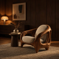 Sculpted lounge chair with an open cutout wood frame and cream cushions in an evening living room with walnut wall paneling