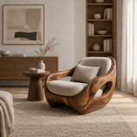 Sculpted lounge chair with open oval side cutouts and a cushioned seat in a Scandinavian living room with white walls