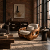Sculpted lounge chair with open oval side cutouts and a cushioned seat in an industrial loft living room with exposed brick