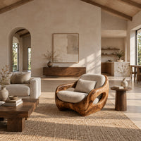 Sculpted lounge chair with open oval side cutouts and a cushioned seat in a bright open plan living room