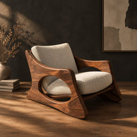 Sculptural lounge chair with oval side cutouts and a cushioned seat, three-quarter view showing the grain