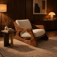 Sculptural lounge chair with oval side cutouts and a cushioned seat in an evening living room with walnut wall paneling