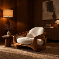 Sculpted lounge chair with oval side cutouts and cream seat cushions in an evening living room with walnut wall paneling