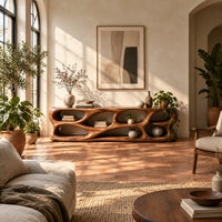 Free form tv stand made of thick sculpted wood with many oval openings in a bright living room with arched windows and plants