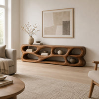 Free form tv stand made of thick sculpted wood with many oval openings in a Scandinavian living room with white walls