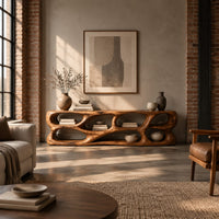 Free form tv stand made of thick sculpted wood with many oval openings in an industrial loft living room with exposed brick