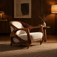 Sculpted lounge chair with an open oval wooden frame and cream cushions in an evening living room with walnut wall paneling