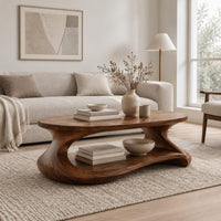 Coffee table with a sculpted pebble base and low shelf in a Scandinavian living room with white walls