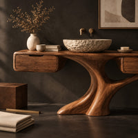 Corner detail of bathroom vanity with a trunk shaped central pedestal and a drawer at each end beside wood, brass and linen samples