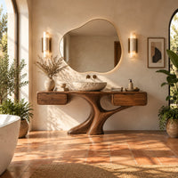 Bathroom vanity with a trunk shaped central pedestal and a drawer at each end in a bright bathroom with arched windows and plants