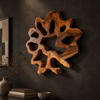 Ring shaped wall art with irregular openings and a wavy outer edge, three-quarter view showing the carved depth