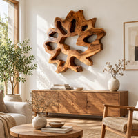 Ring shaped wall art with irregular openings and a wavy outer edge in a bright sunroom with green plants